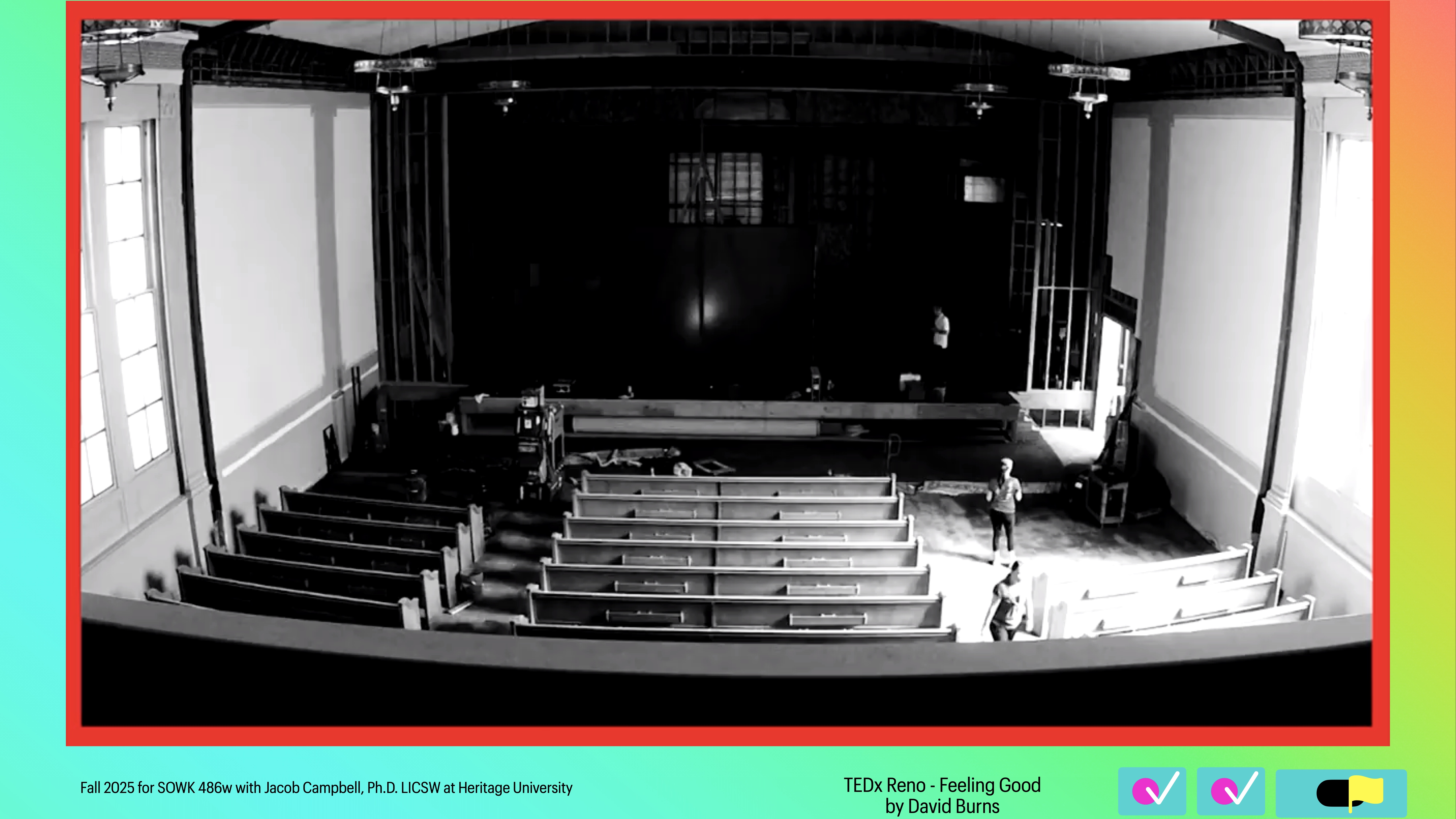 A person stands in an empty auditorium with rows of seats facing a stage. Text at the bottom reads: 'TEDx Reno - Feeling Good by David Burns. Fall 2023 for SWK 498w with Jacob Campbell, Ph.D. LICSW at Heritage University.'